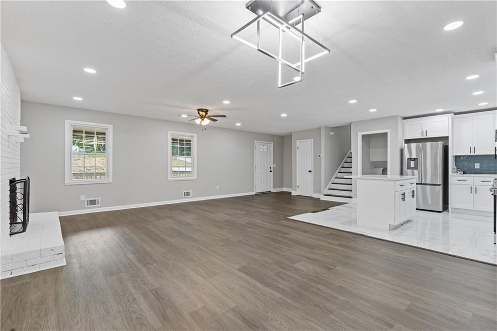 353 Old Rosser Road Stone Mountain, GA 30087 - Photo 15 of 46 a view of a livingroom with a ceiling fan window and wooden floor