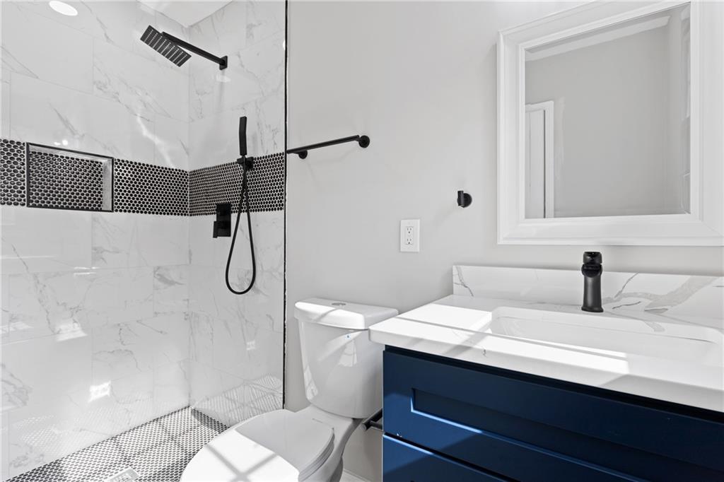 353 Old Rosser Road Stone Mountain, GA 30087 - Photo 24 of 46 a bathroom with a sink and mirror