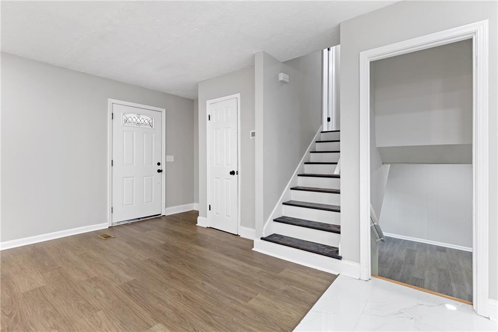353 Old Rosser Road Stone Mountain, GA 30087 - Photo 26 of 46 wooden floor in an empty room with wooden floor and entryway