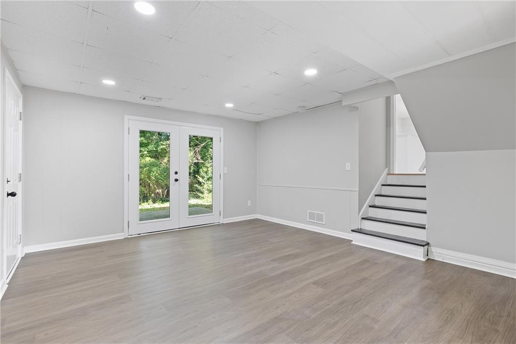 353 Old Rosser Road Stone Mountain, GA 30087 - Photo 28 of 46 wooden floor in an empty room with a window