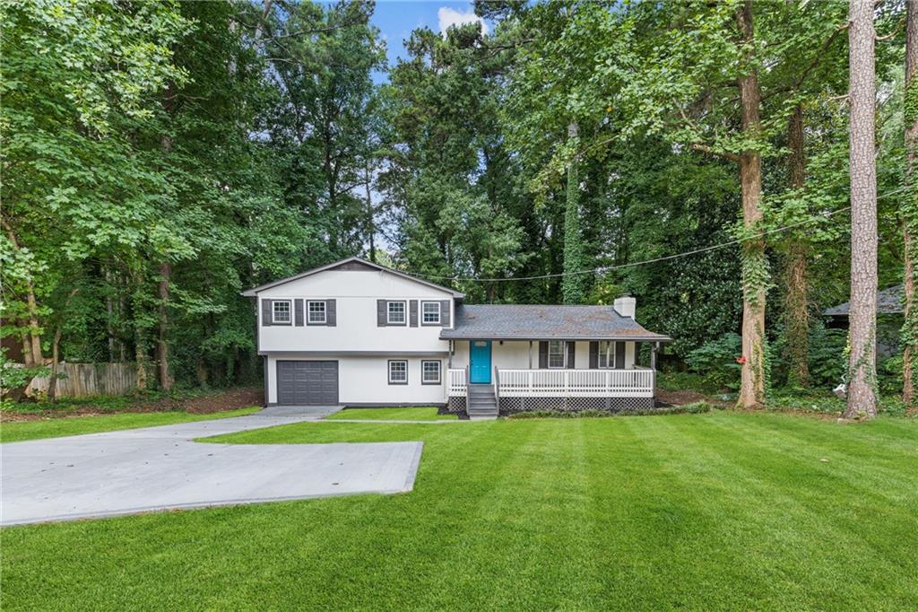 353 Old Rosser Road Stone Mountain, GA 30087 - Photo 39 of 46 a front view of a house with a yard table and chairs