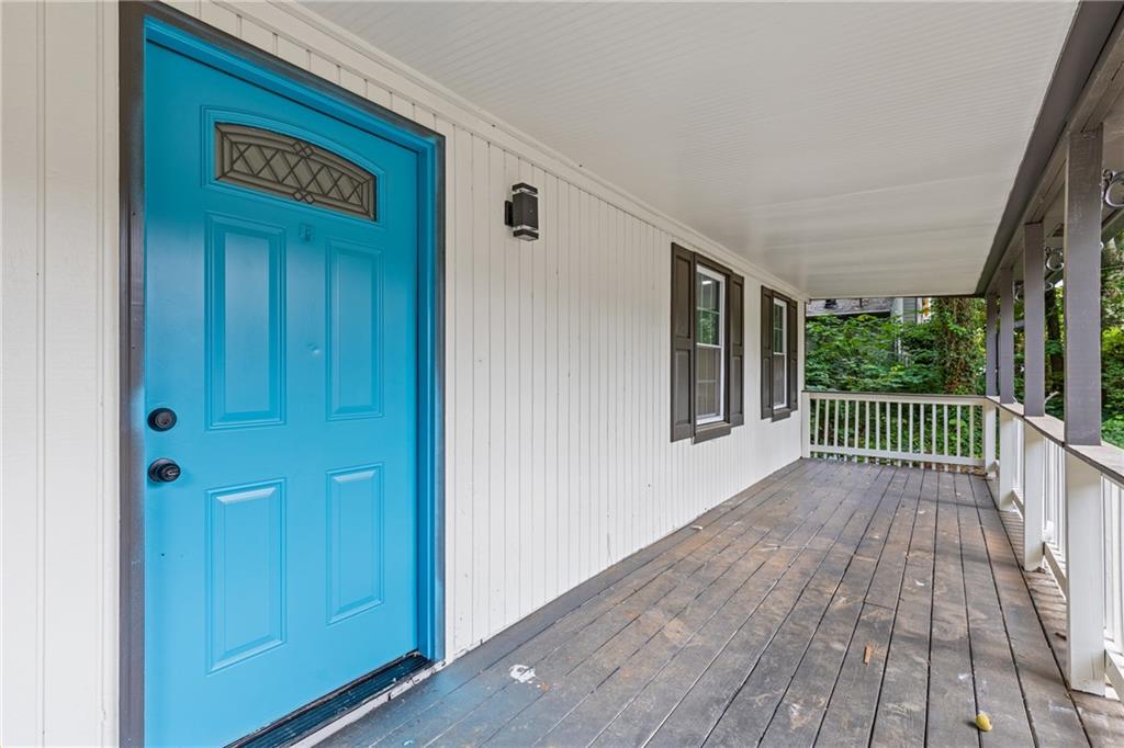 353 Old Rosser Road Stone Mountain, GA 30087 - Photo 6 of 46 a view of a porch with wooden floor and stairs