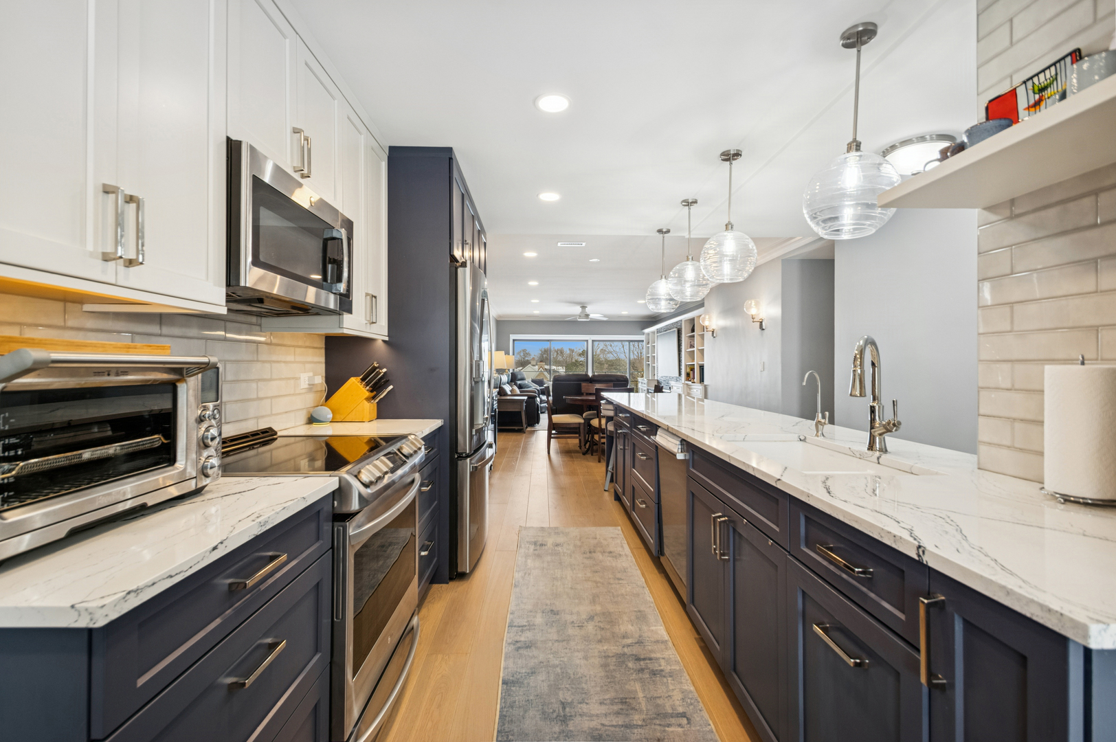 1 North Dee Road, Unit 3G Park Ridge, IL 60068 - Photo 6 of 24 a kitchen with stainless steel appliances granite countertop a sink a stove top oven a counter space and cabinets