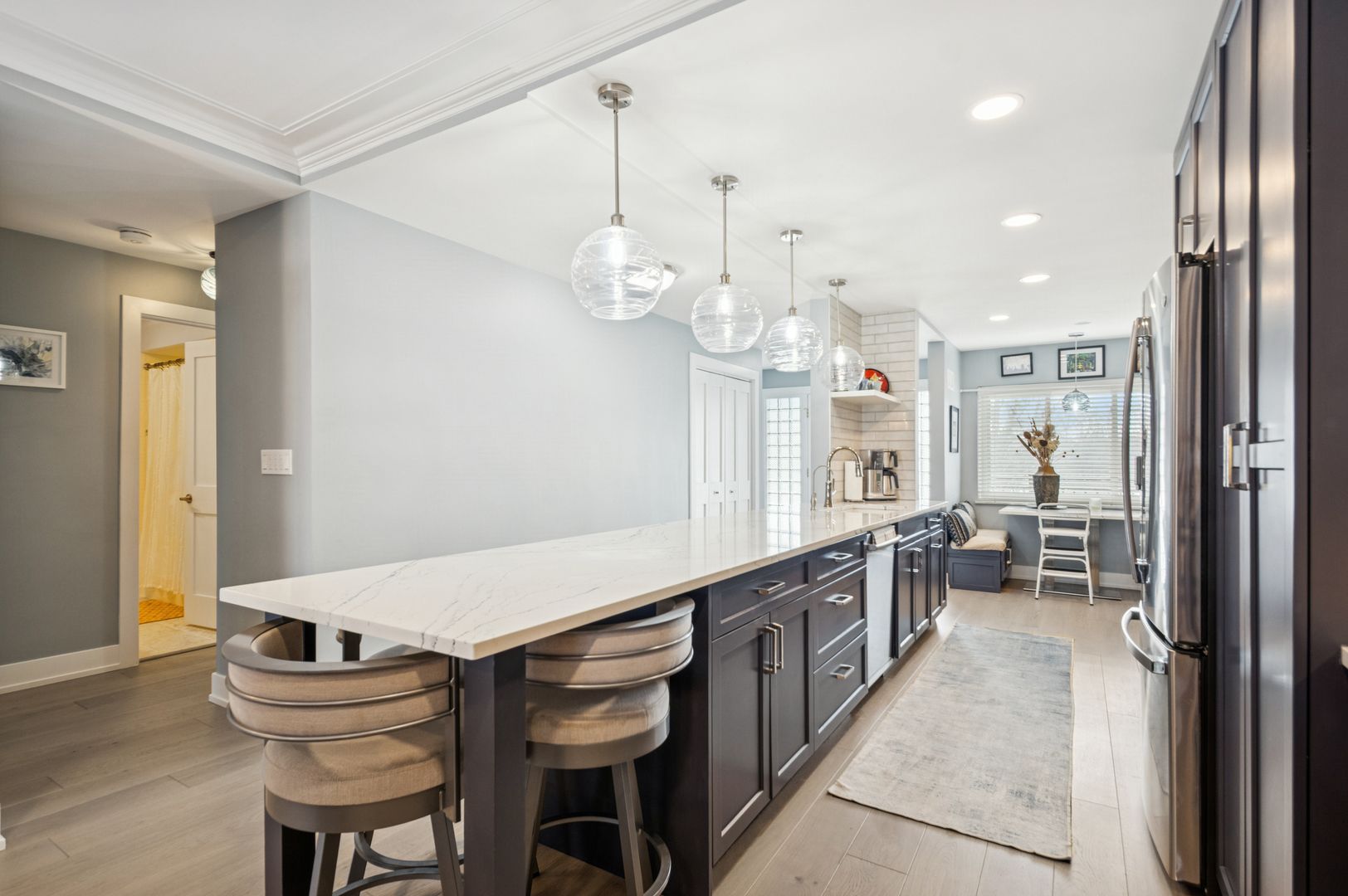 1 North Dee Road, Unit 3G Park Ridge, IL 60068 - Photo 8 of 24 a kitchen with granite countertop a table chairs stove and a chandelier