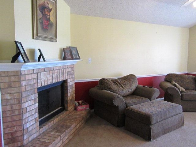6514 89th Street Lubbock, TX 79424 - Photo 3 of 10 a living room with furniture and a fireplace