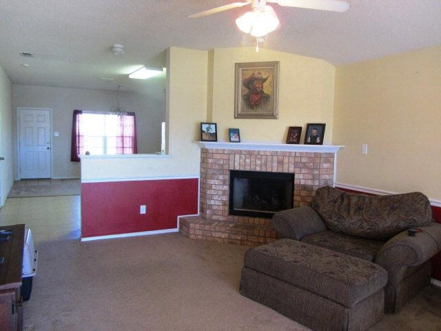 6514 89th Street Lubbock, TX 79424 - Photo 4 of 10 a living room with furniture and a fireplace