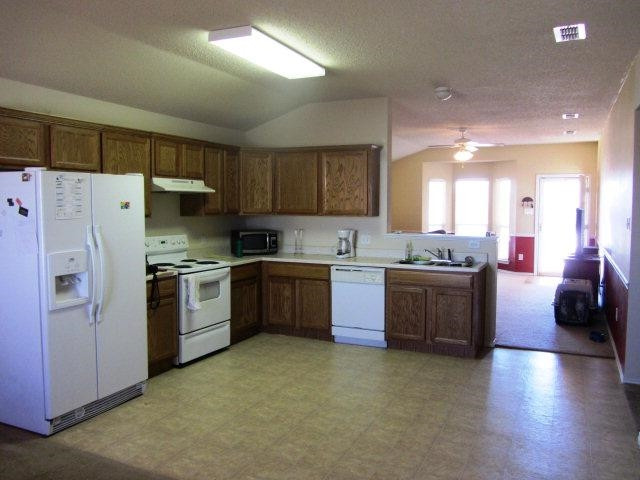 6514 89th Street Lubbock, TX 79424 - Photo 5 of 10 a kitchen with granite countertop a sink stainless steel appliances and cabinets