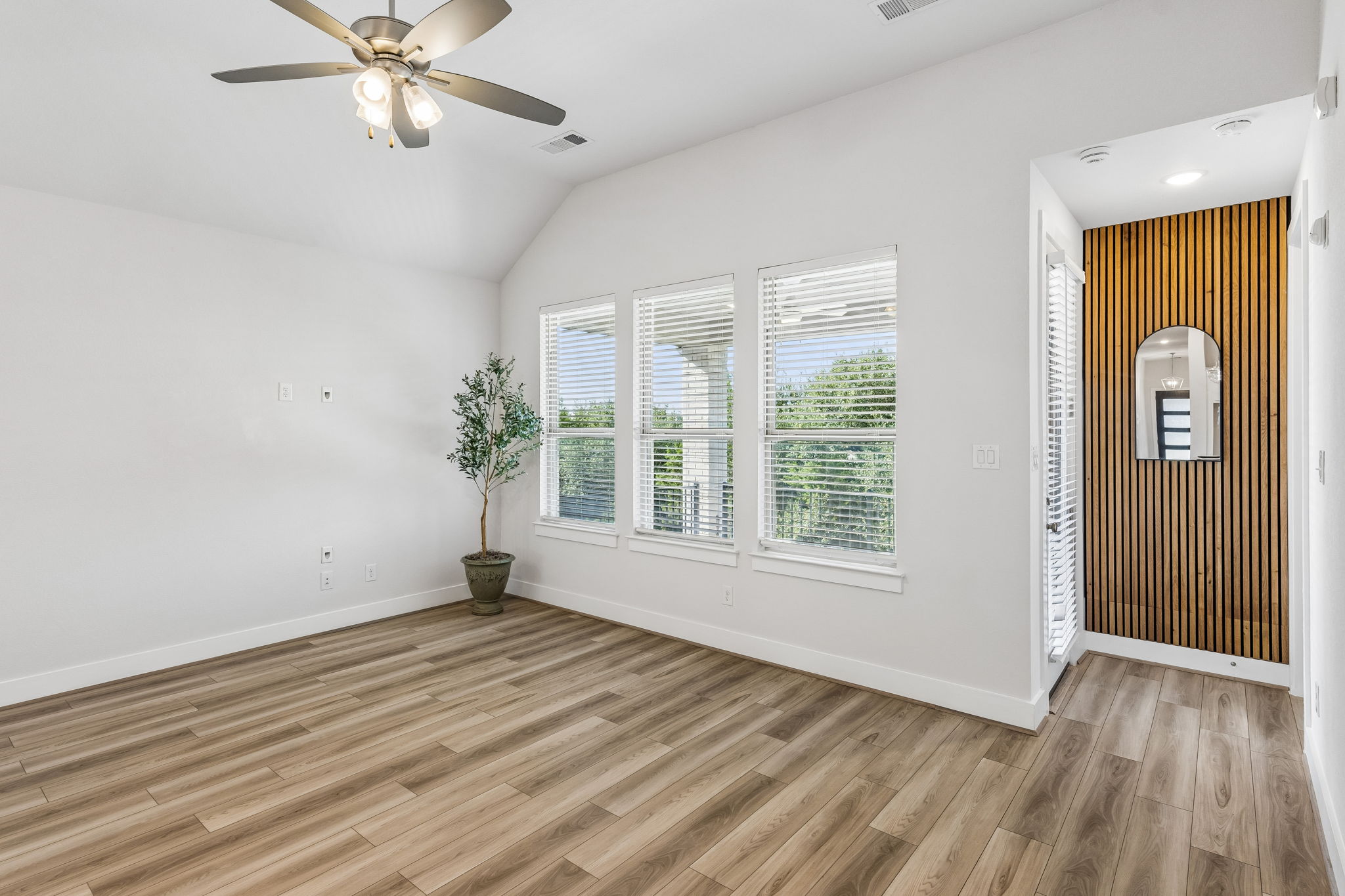 228 Arrowhead Mound Road Georgetown, TX 78628 - Photo 12 of 34 A naturally illuminated living area features high ceilings and sleek wood flooring, offering a fresh, open ambiance.