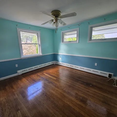 a view of room with window and wooden floor