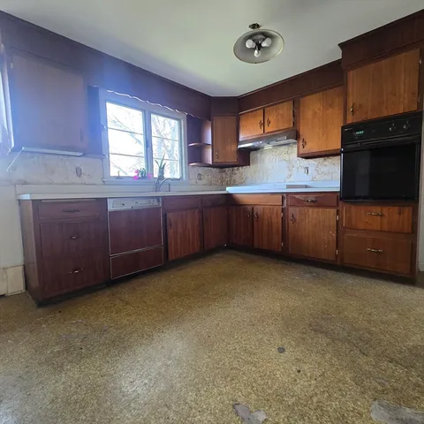 a kitchen with cabinets a sink and wooden floor