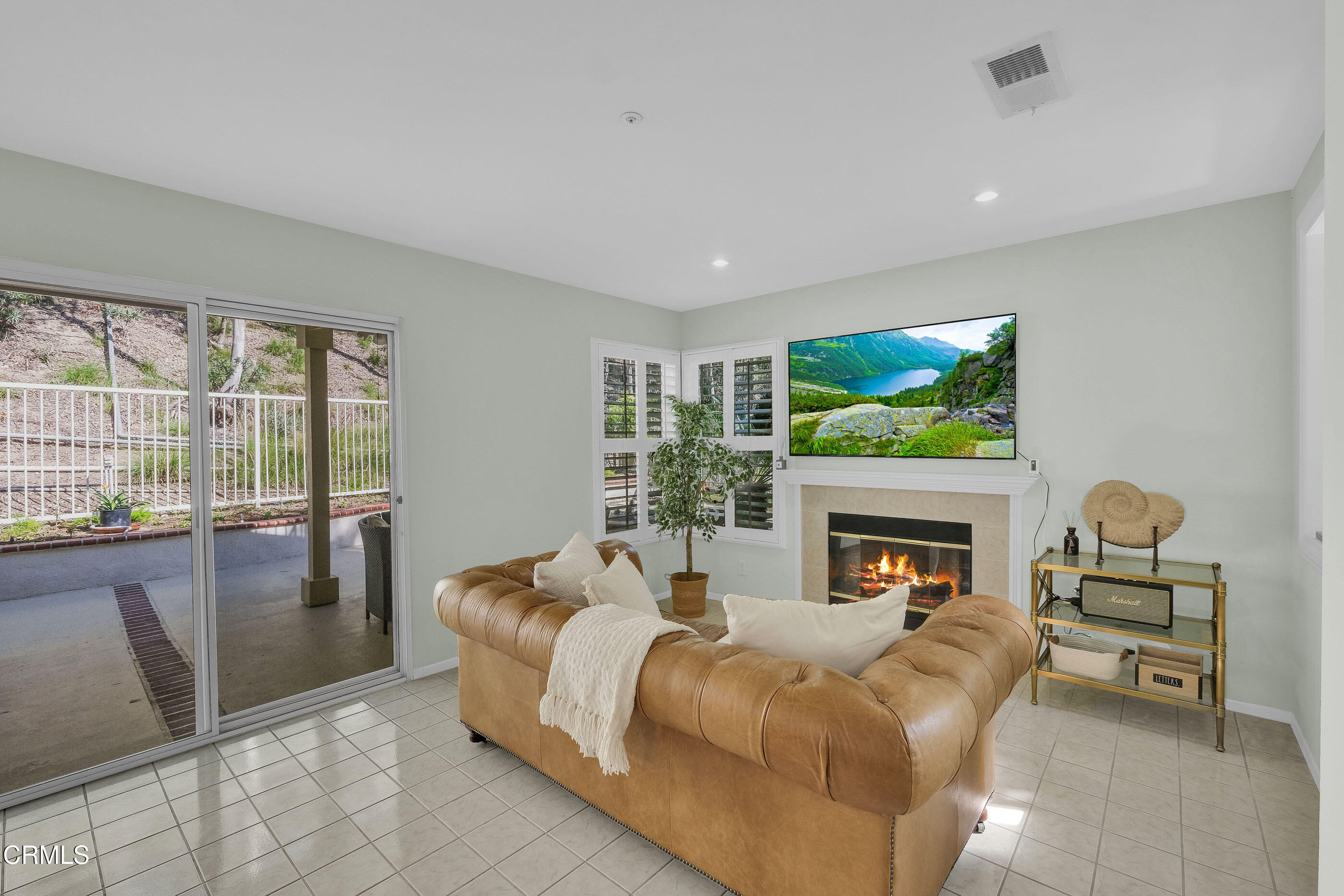 878 Calle La Primavera Glendale, CA 91208 - Photo 11 of 35 a bed room with furniture and a fireplace