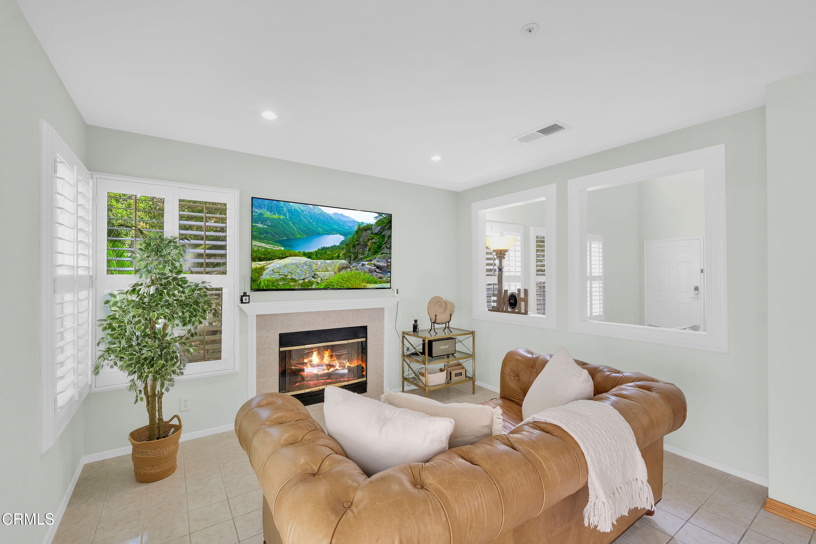 878 Calle La Primavera Glendale, CA 91208 - Photo 12 of 35 a living room with furniture a flat screen tv and a fireplace