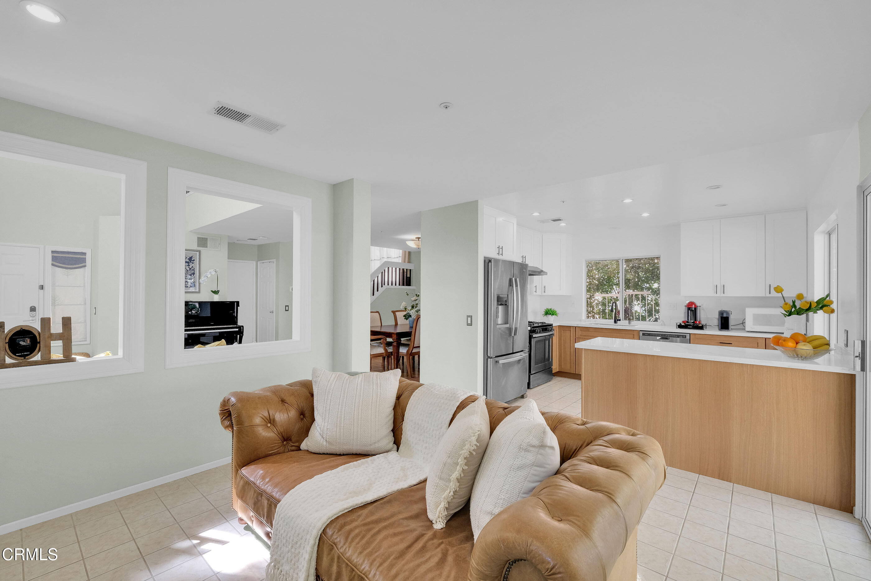 878 Calle La Primavera Glendale, CA 91208 - Photo 13 of 35 a living room with furniture and a dining table with wooden floor