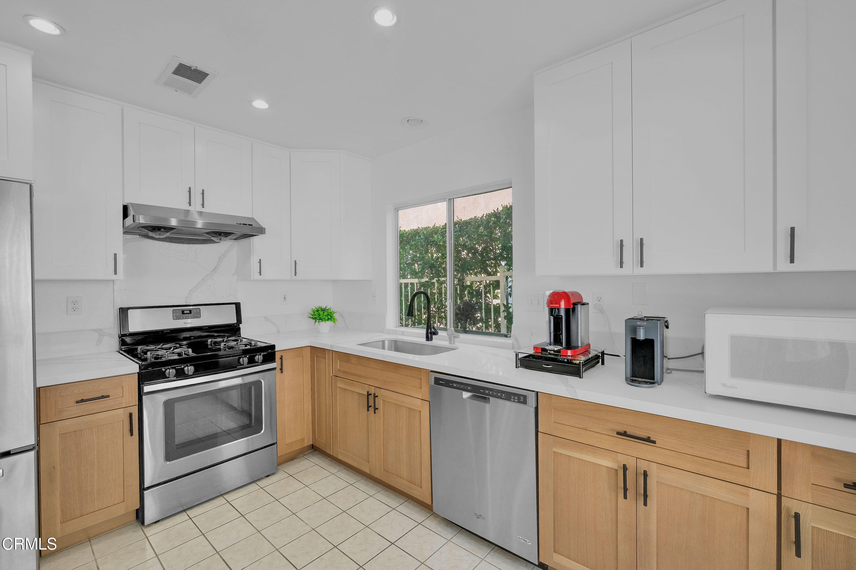 878 Calle La Primavera Glendale, CA 91208 - Photo 8 of 35 a kitchen with cabinets stainless steel appliances and a sink