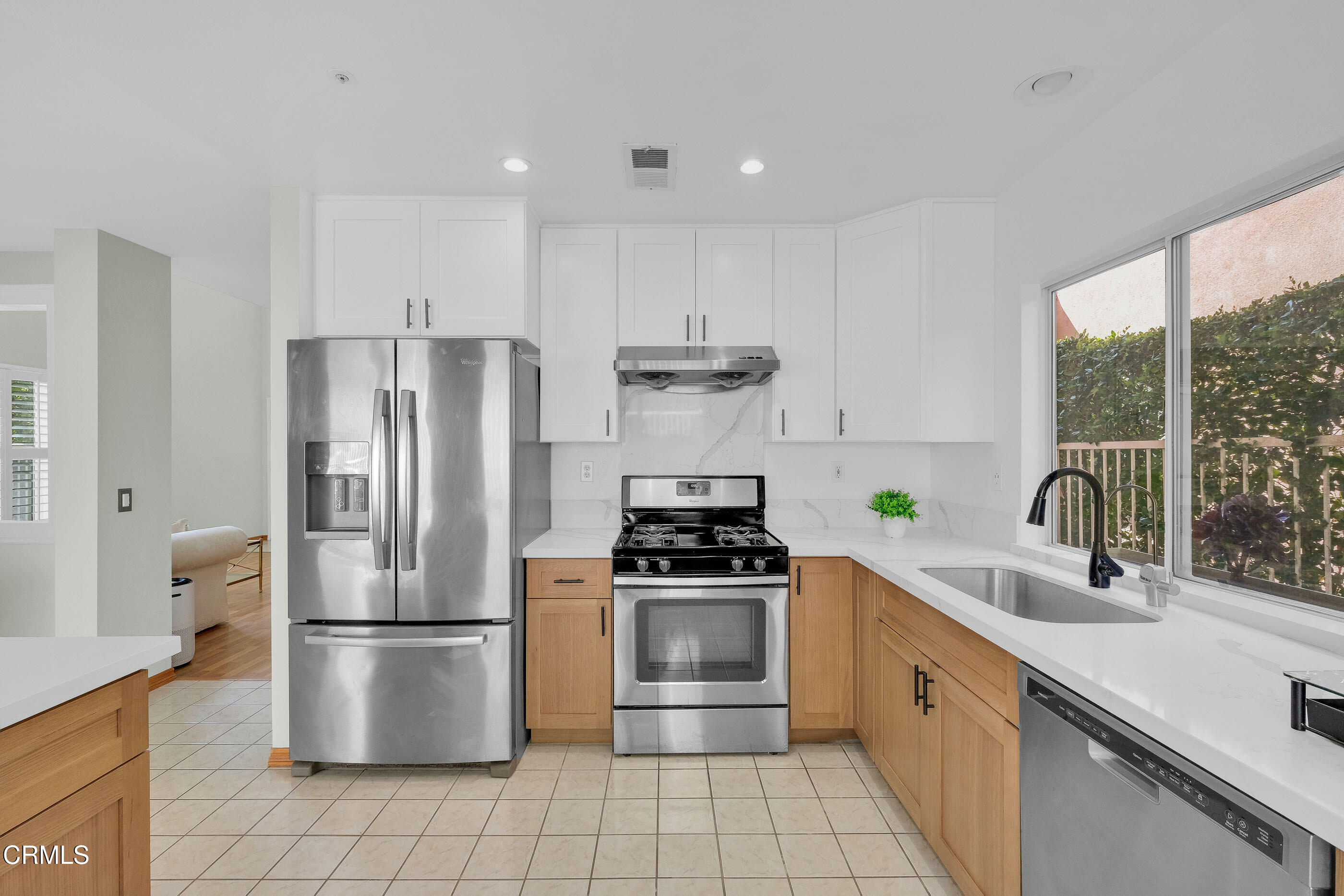 878 Calle La Primavera Glendale, CA 91208 - Photo 9 of 35 a kitchen with a refrigerator sink and wooden cabinets