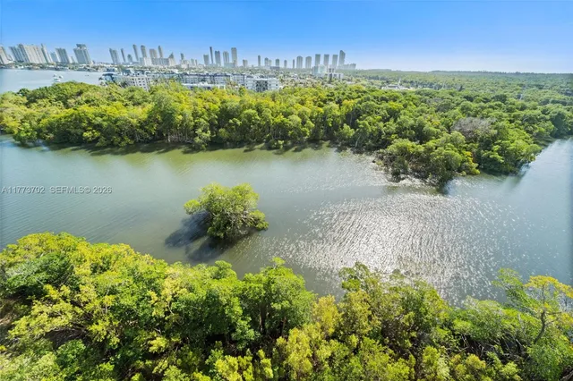 a kitchen with a dining table chairs and a flat screen tv