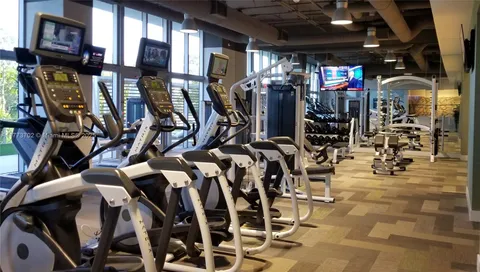 a view of a balcony with chairs and wooden floor