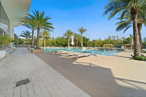 a view of a backyard with swimming pool table and chairs