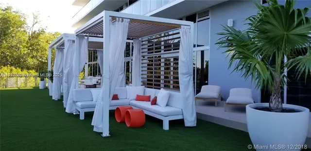 a view of a garden with lawn chairs