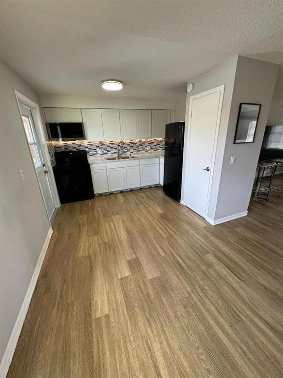 1649 West Oak Ridge Road, Unit 1649C Orlando, FL 32809 - Photo 2 of 8 a view of kitchen with refrigerator sink and cabinets