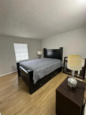 a bedroom with two beds and lamp