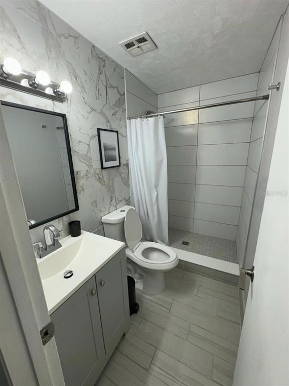 1649 West Oak Ridge Road, Unit 1649C Orlando, FL 32809 - Photo 4 of 8 a bathroom with a toilet sink and shower