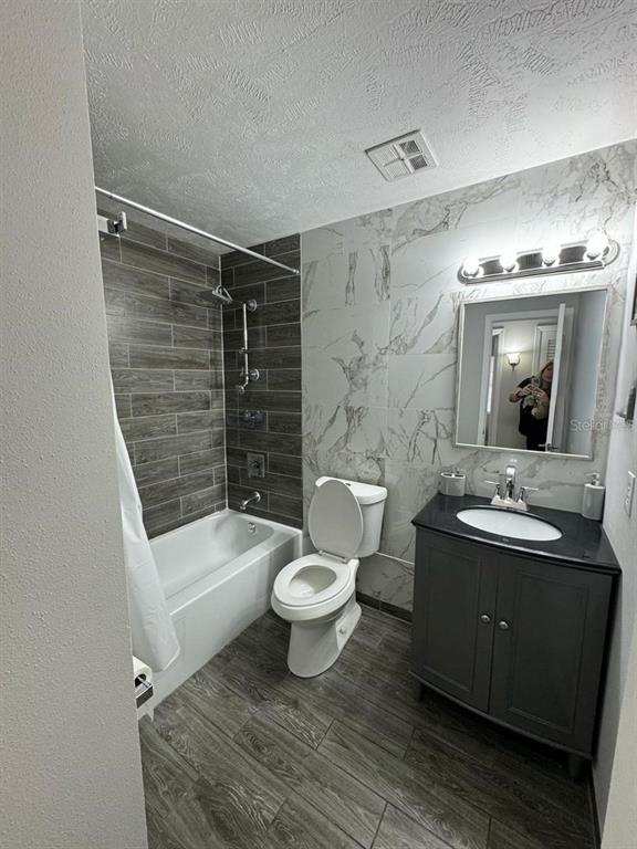 1649 West Oak Ridge Road, Unit 1649C Orlando, FL 32809 - Photo 5 of 8 a bathroom with a sink toilet and shower