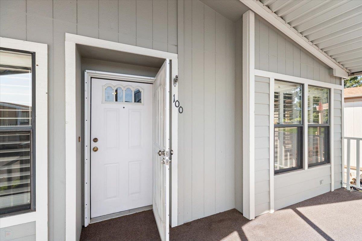 1500 Held Drive, Unit 100 Modesto, CA 95355 - Photo 2 of 59 a view of a livingroom and a bathroom with a wooden door