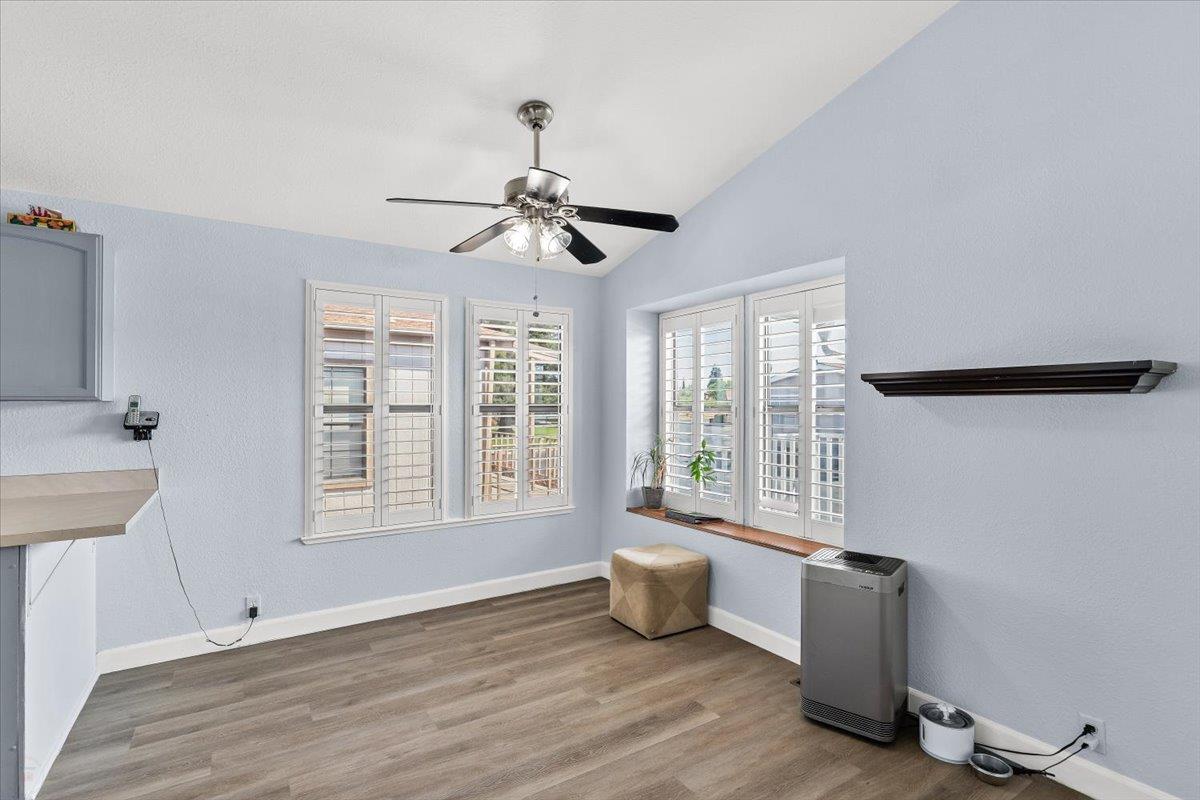1500 Held Drive, Unit 100 Modesto, CA 95355 - Photo 21 of 59 a view of an empty room with a window and wooden floor