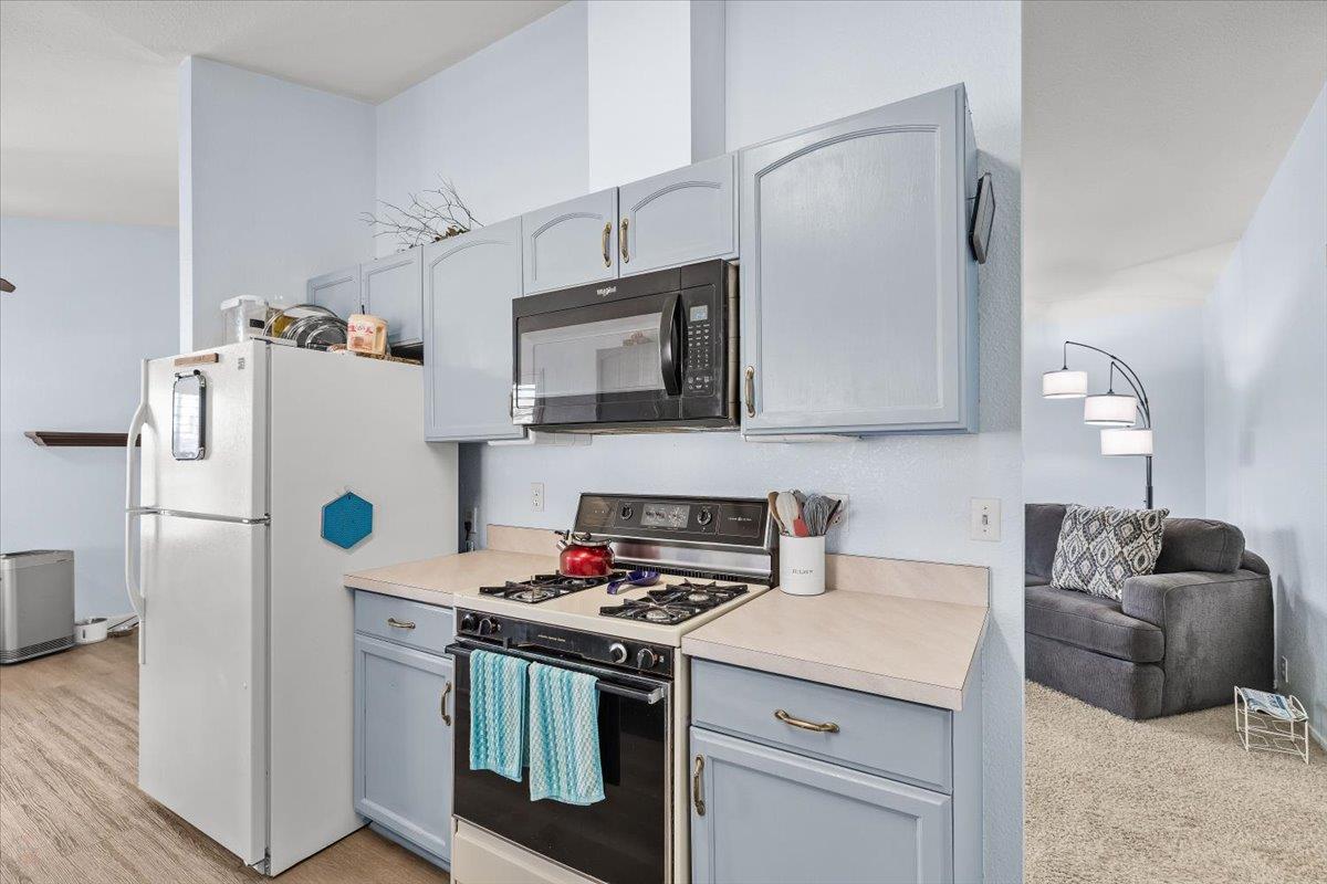 1500 Held Drive, Unit 100 Modesto, CA 95355 - Photo 25 of 59 a kitchen with stainless steel appliances a refrigerator stove and microwave