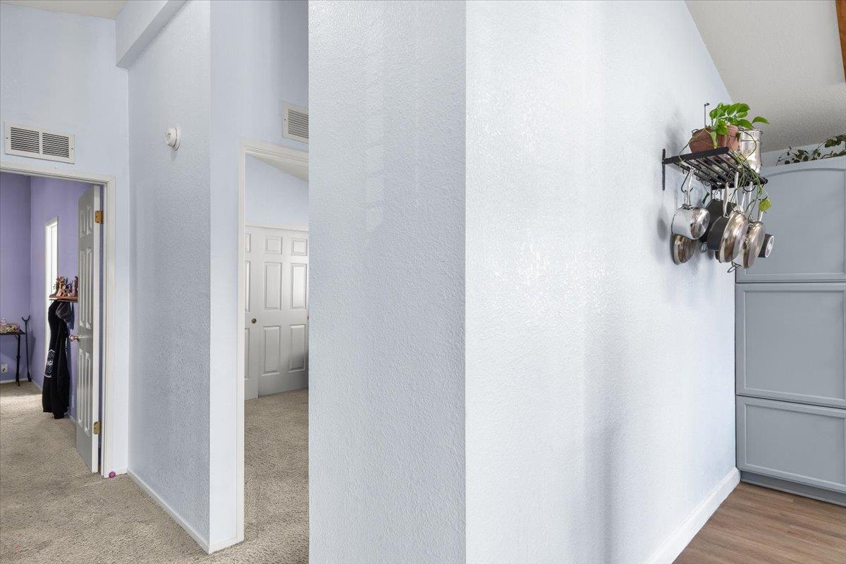 1500 Held Drive, Unit 100 Modesto, CA 95355 - Photo 26 of 59 a view of a hallway with wooden floor