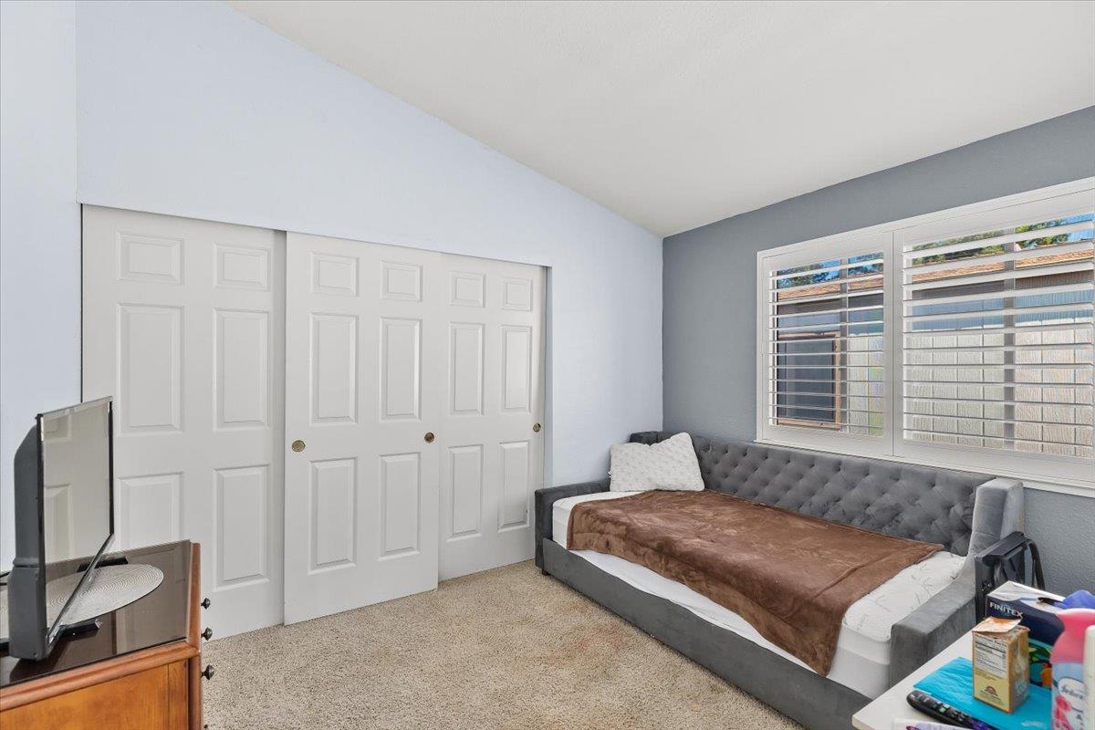 1500 Held Drive, Unit 100 Modesto, CA 95355 - Photo 27 of 59 a bedroom with a bed a window and potted plant on a dresser