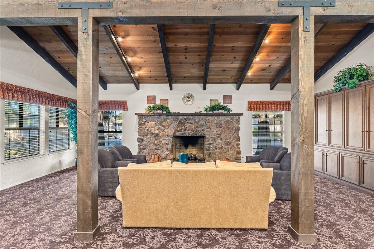1500 Held Drive, Unit 100 Modesto, CA 95355 - Photo 36 of 59 a living room with furniture a fireplace and a table