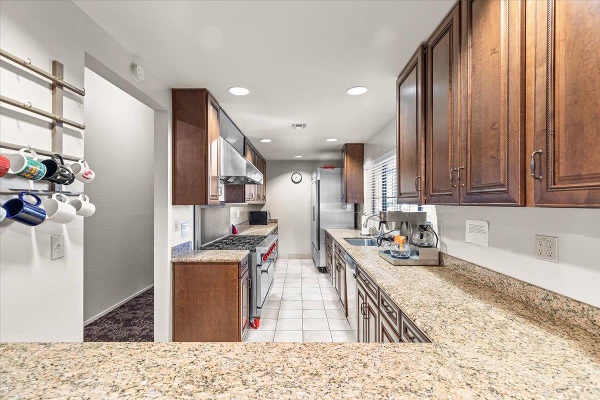1500 Held Drive, Unit 100 Modesto, CA 95355 - Photo 46 of 59 a kitchen with stainless steel appliances kitchen island granite countertop a sink stove and refrigerator