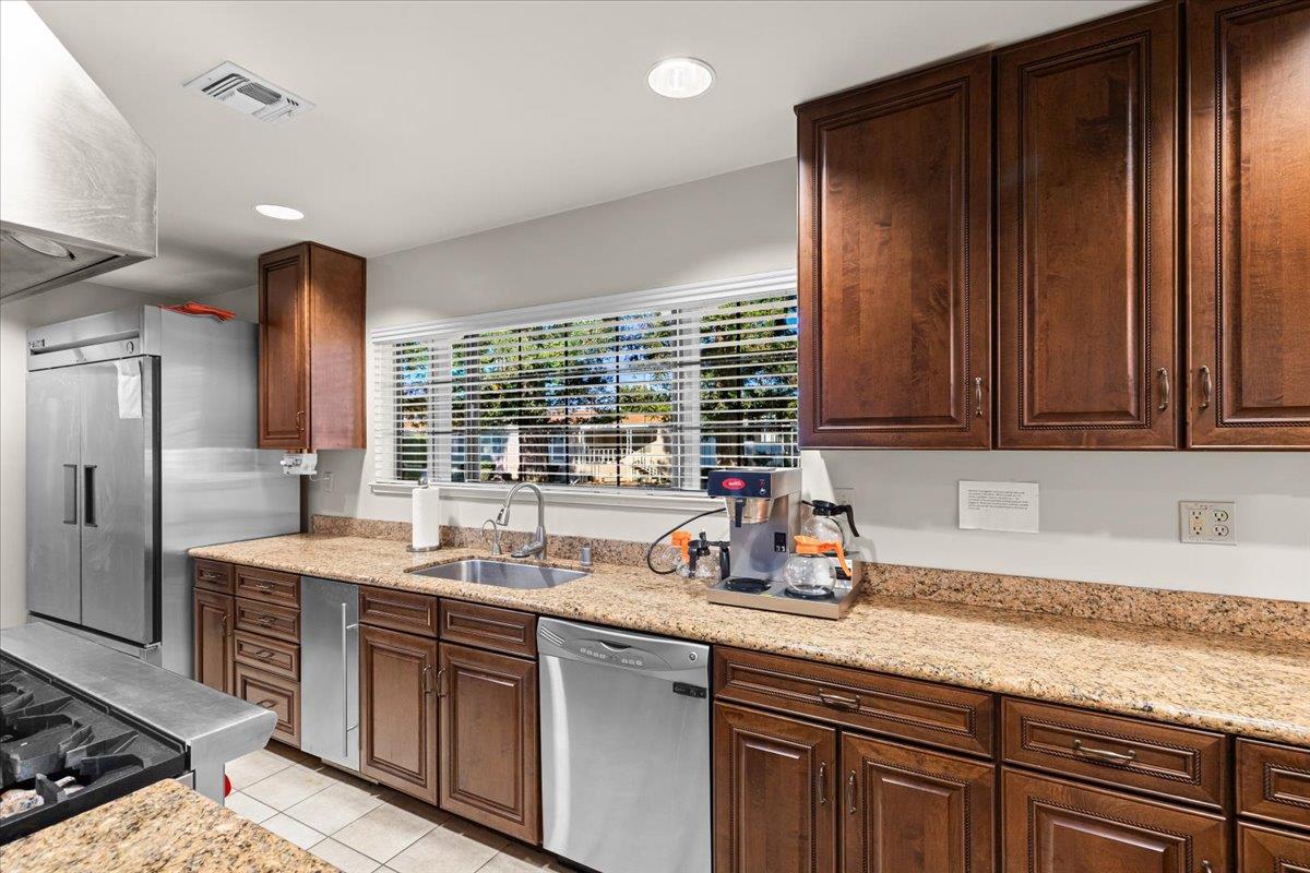 1500 Held Drive, Unit 100 Modesto, CA 95355 - Photo 47 of 59 a kitchen with stainless steel appliances granite countertop a sink stove and refrigerator
