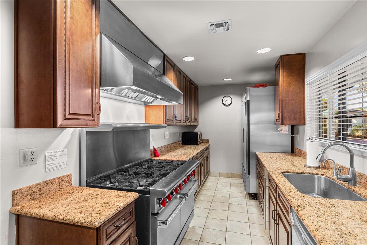 1500 Held Drive, Unit 100 Modesto, CA 95355 - Photo 48 of 59 a kitchen with stainless steel appliances granite countertop a sink stove and refrigerator