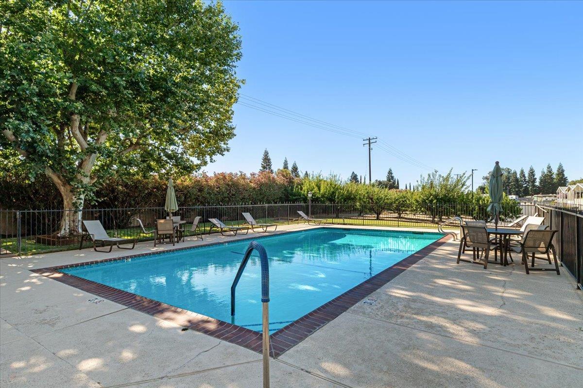 1500 Held Drive, Unit 100 Modesto, CA 95355 - Photo 54 of 59 a view of a swimming pool with a lounge chair