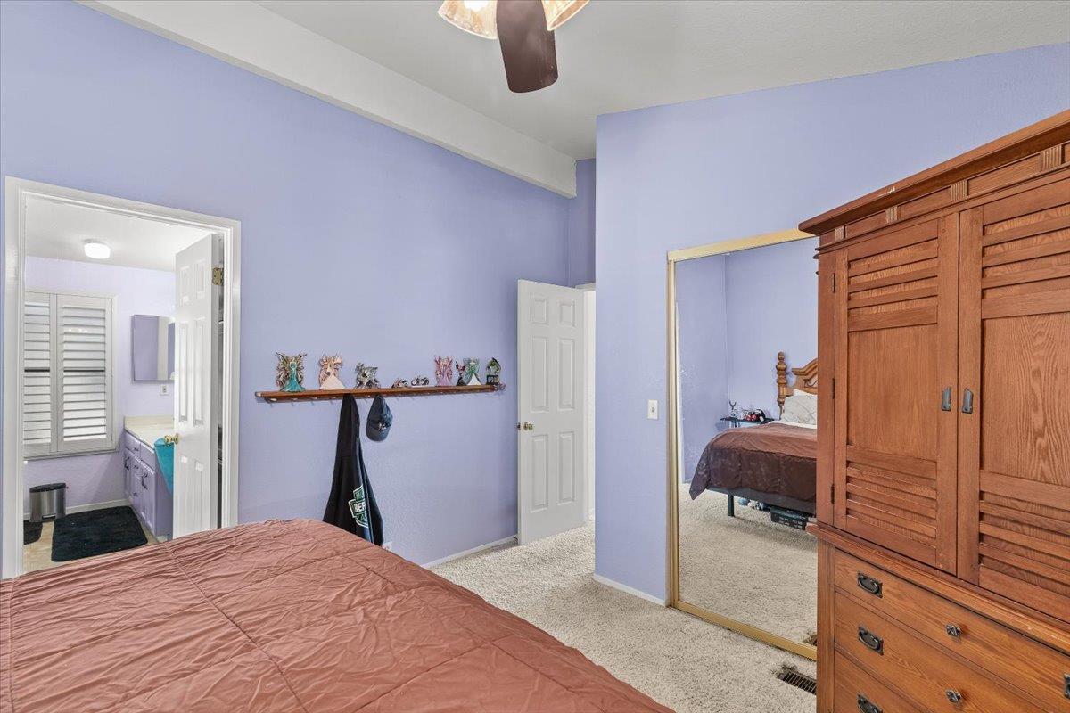 1500 Held Drive, Unit 100 Modesto, CA 95355 - Photo 6 of 59 a bedroom with a bed and a view of living room