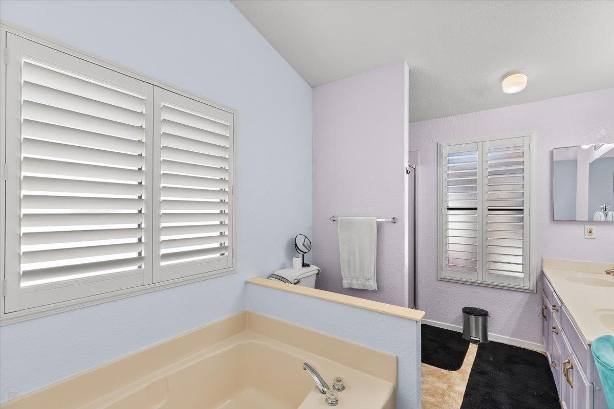 1500 Held Drive, Unit 100 Modesto, CA 95355 - Photo 7 of 59 a bathroom with a bathtub and a window