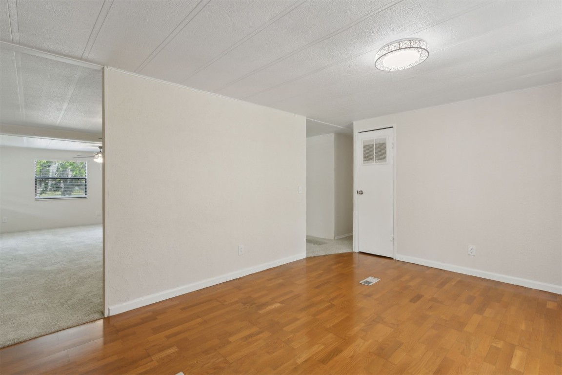 2889 Santa Fe Trail Hilliard, FL 32046 - Photo 12 of 49 an empty room with wooden floor and windows