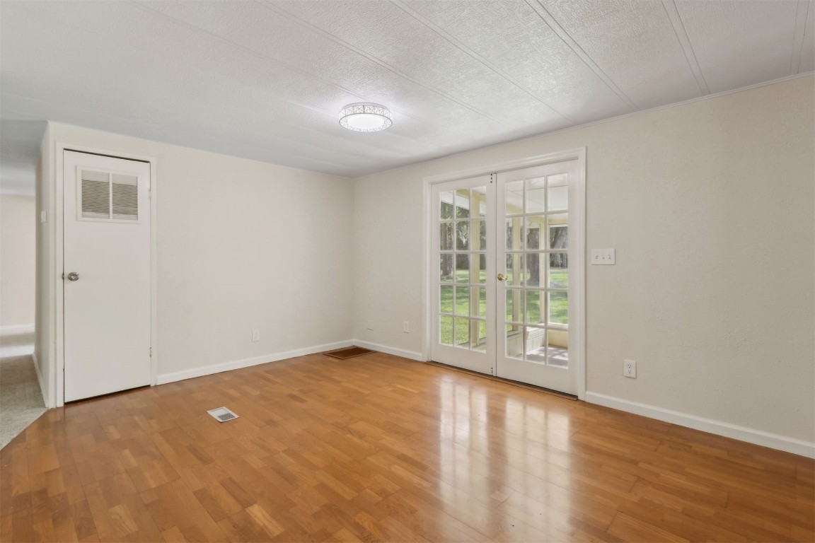 2889 Santa Fe Trail Hilliard, FL 32046 - Photo 13 of 49 an empty room with wooden floor and windows