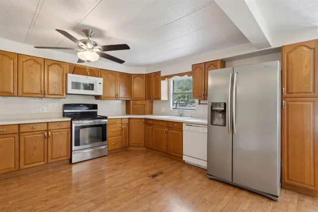 a kitchen with a refrigerator stove and sink