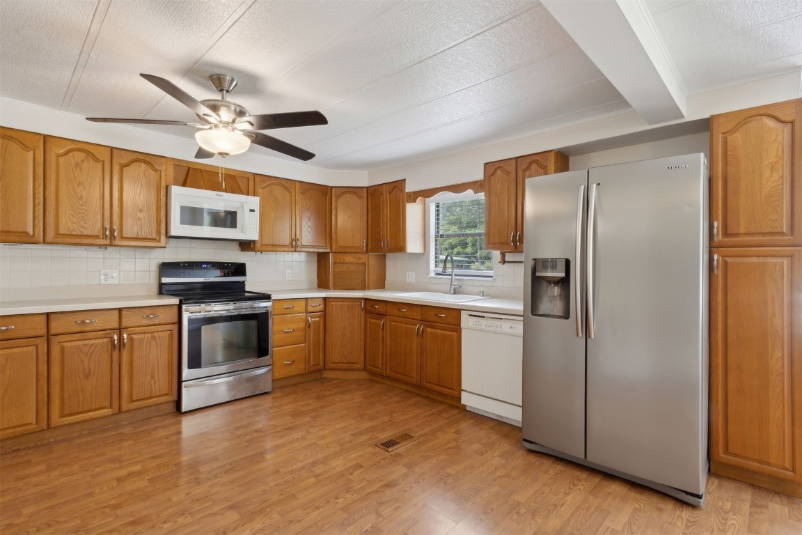2889 Santa Fe Trail Hilliard, FL 32046 - Photo 16 of 49 a kitchen with a refrigerator stove and sink