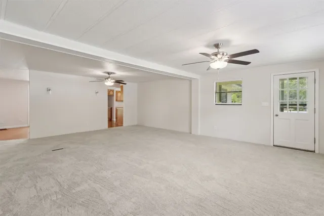 a view of an empty room with a ceiling fan