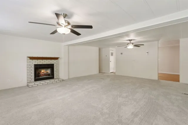 a view of an empty room with a fireplace