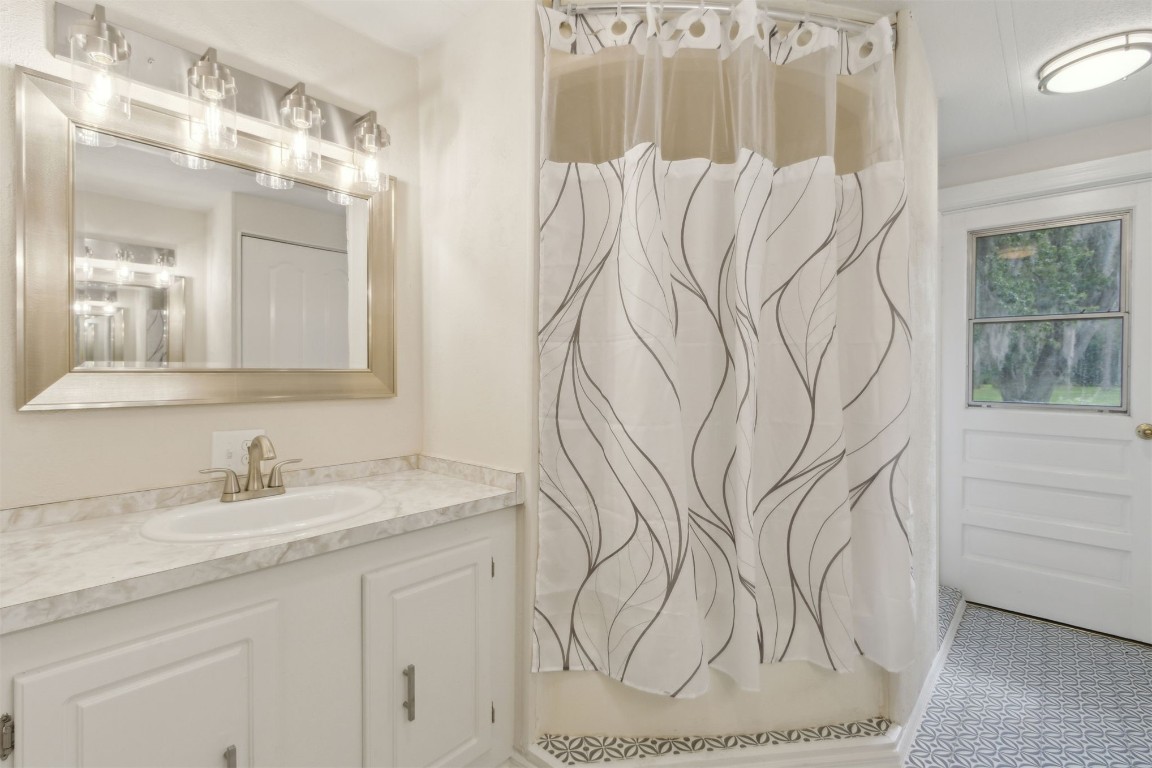 2889 Santa Fe Trail Hilliard, FL 32046 - Photo 27 of 49 a bathroom with a sink and mirror