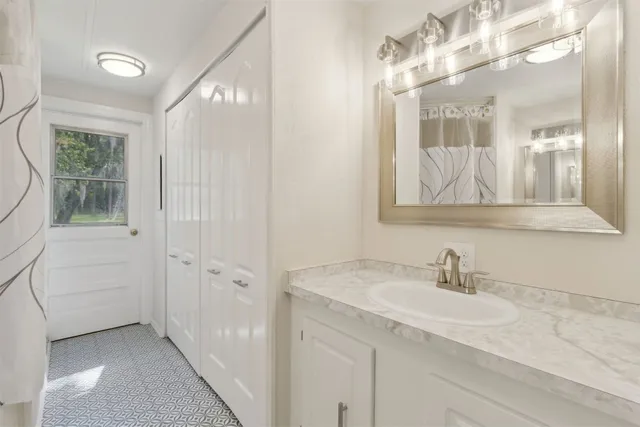 a bathroom with a sink a vanity and a mirror