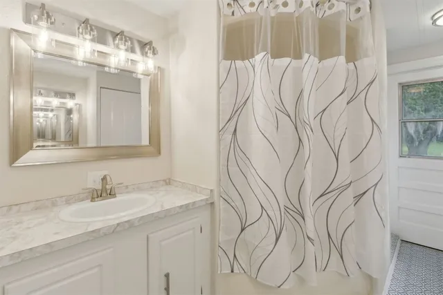 a bathroom with a sink and mirror