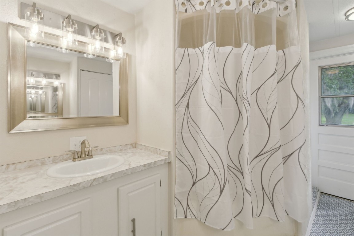 2889 Santa Fe Trail Hilliard, FL 32046 - Photo 29 of 49 a bathroom with a sink and mirror