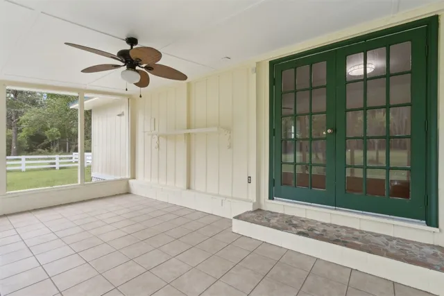 a view of a room that has a large window and a rug